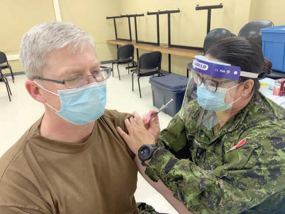BComd LCol Chris Wood enjoys rolling up his sleeve during the pandemic to receive his COVID needle
