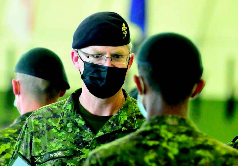 CFB Shilo BComd LCol Chris Wood speaking with a DBMQ graduate