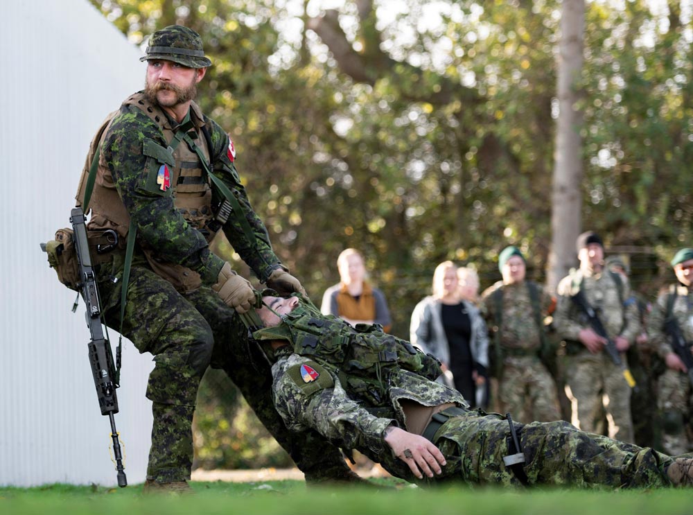 UK-retrieve-1 BComd Col Douglas Gunter sits with the Royal family during Queen Elizabeth II's visit to CFB Shilo in 1970.