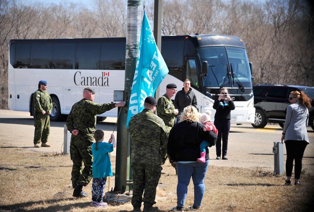 PHOTO ESSAY:  Military child helps raise flag for Teal Up for military kids month
