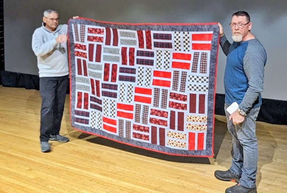 Shilo Veterans wrapped in hugs with Quilts of Valour awards